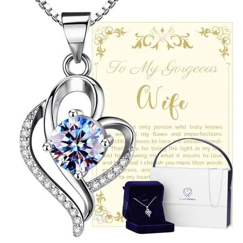 A sparkling moissanite diamond pendant necklace on a silver chain, displayed in a gift box.